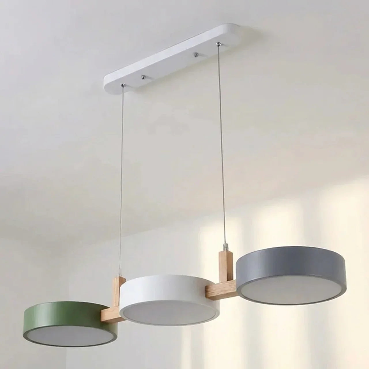 Suspension à poutre en bois avec abat-jours métalliques cylindriques pour îlot de cuisine